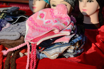 Stack of winter hats at market stall