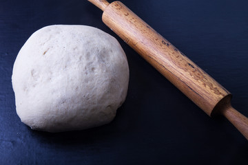 Rolling pin and dough for pie. Toned