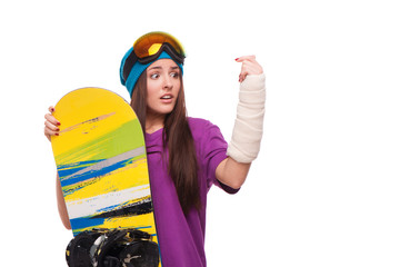 Scared woman with broken arm and snowboard