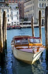 Traditional motorboat taxi moored in marina in Venice