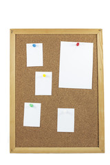 cork board with blank paper notes