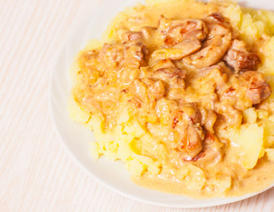 meat with sauce and mashed potatoes