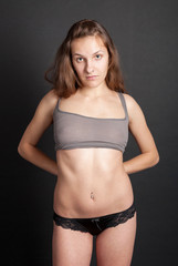 Semi-nude slim girl in panties