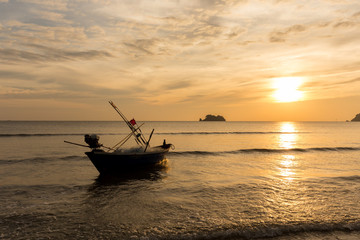 Fisherman boat silhouette with sunset