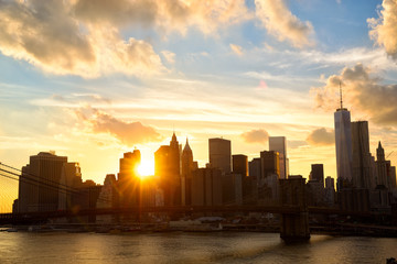 Manhattan skyline with Brooklyn Bridge at sunset, New York City