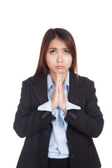 Young Asian businesswoman pray with unhappy face