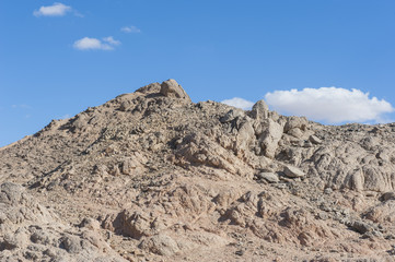Fototapeta na wymiar Rocky desert mountain with blue sky background