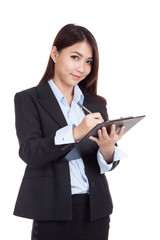 Young Asian businesswoman  write on clipboard