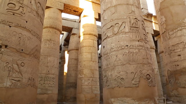 columns in karnak temple with ancient egypt hieroglyphics - tilt
