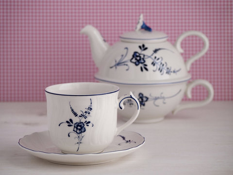 Vintage teacup and teapot with floral motif
