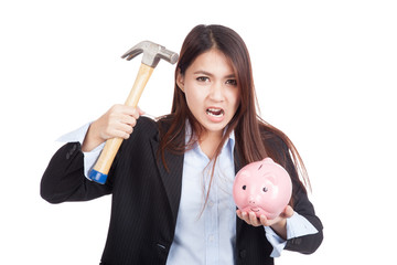Young Asian businesswoman with hammer and  piggy bank © halfbottle