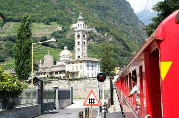 Bernina express train arriving at Tirano on Italy - obrazy, fototapety, plakaty