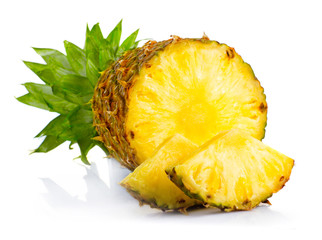 Fresh pineapple fruits with cut and green leaves isolated