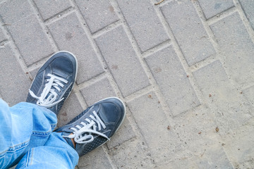 man feet on cobbled road