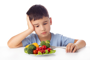 Boy eating vegetables