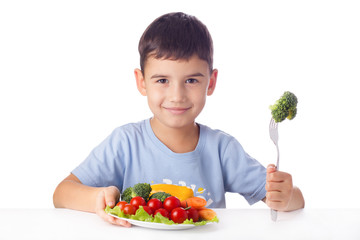 Boy eating vegetables