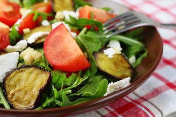 Eggplant salad with tomatoes, arugula and feta cheese,