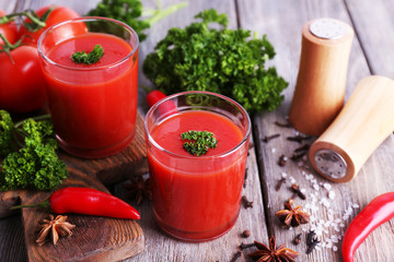 Tomato juice in glasses and fresh vegetables
