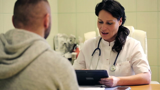 Female Doctor Telling Good News To Patient In Hospital