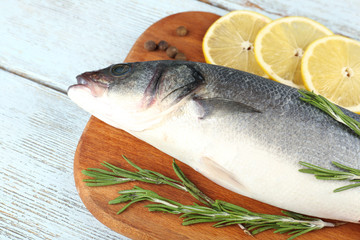 Fresh raw fish and food ingredients on table