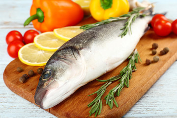 Fresh raw fish and food ingredients on table