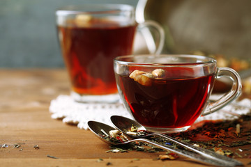 Beautiful vintage composition with herbal tea, on wooden table