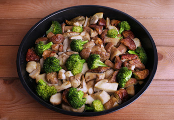 Braised wild mushrooms with vegetables and spices in pan