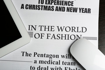 On-line news concept.Computer mouse, PC tablet and newspaper,