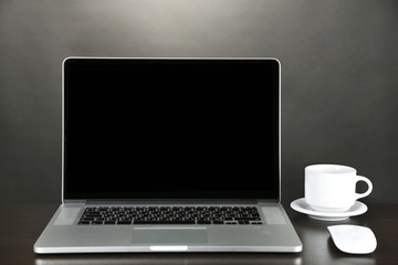 Fototapeta premium Modern laptop on table, on grey background