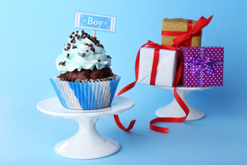 Delicious cupcake with inscription on blue background