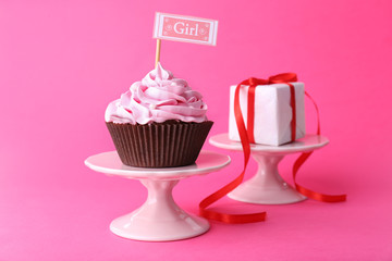 Delicious cupcake with inscription on pink background