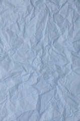 Blue crumpled paper as background