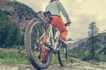 Fototapeta premium Woman standing on her bike
