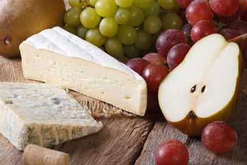 Cheese with grapes and pears close-up horizontal