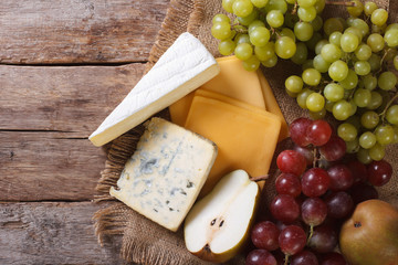 grapes, pears and cheese on the table. horizontal top view