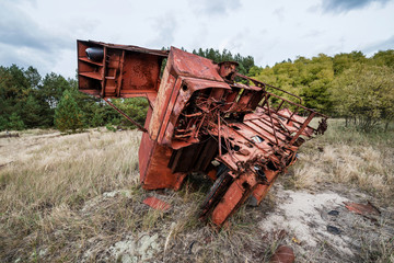 combine harvester on junk yard near Illinci in Chernobyl Zone