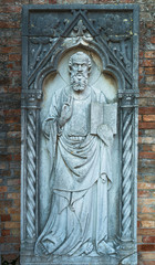 Fototapeta na wymiar Stone statue of a saint, Torcello island, Venice, Italy