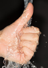 Fototapeta premium hand in water on a black background