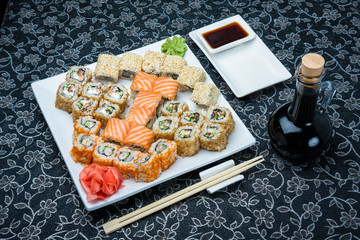 Sushi set turned into salmon with soy sauce in the bottle