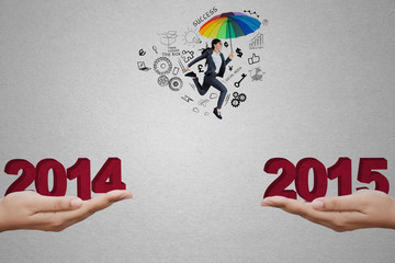 Entrepreneur with umbrella jumping through a slit