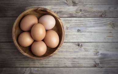 Fotobehang eggs in a wooden bowl © Mamuka Gotsiridze