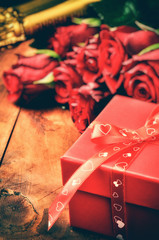 Valentine's setting with red roses and gift box
