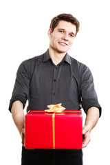 Holiday. Man giving red gift box with golden ribbon