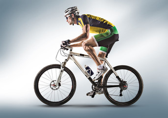 Cyclist riding a bicycle isolated against white background