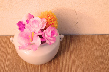 artificial flower in white jar