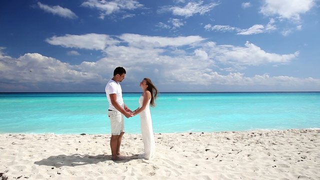 Young beautiful newlyweds doing  pledge of allegiance on white s