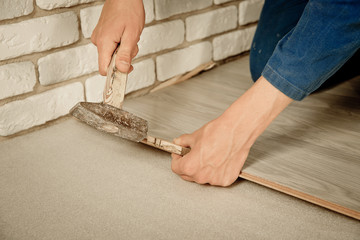 Installing laminate flooring fitting the next piece - focus on h