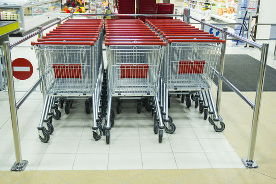 Rows of supermarket shopping cart trolleys