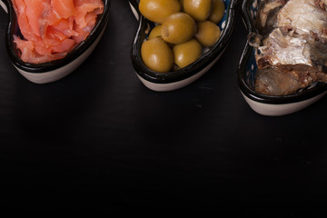 Assorty of fish and olives on oriental dish