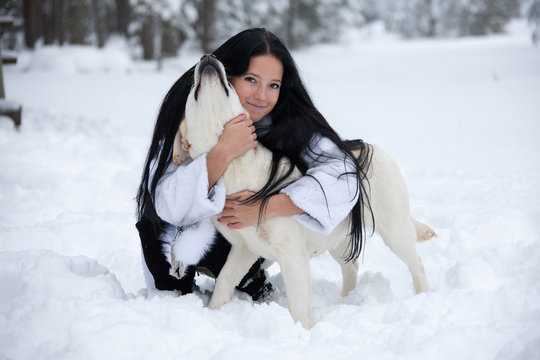 beautiful young woman playing with labrador dog